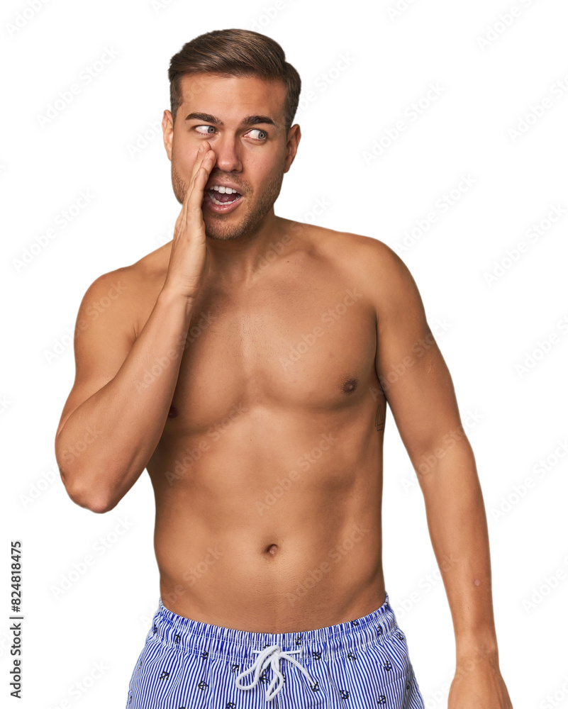 Young man shirtless in swimwear, studio is saying a secret hot braking news and looking aside Young man shirtless in swimwear, studio is saying a secret hot braking news and looking aside