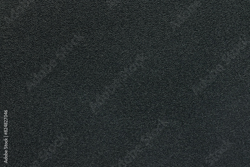 A sheet of black plastic as a background or texture, close-up.