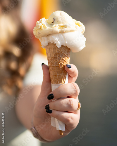 Cone of delicious ice cream in one hand.