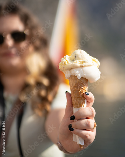 Cone of delicious ice cream in one hand.