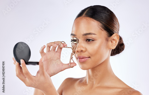 Woman, eyelash curler and beauty in studio with mirror for cosmetics, self care or grooming treatment on white background. Spa, aesthetic and female model for routine, makeover or product on mockup