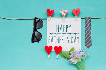 Happy Father's day card with sunglasses and necktie on blue background, greeting card background idea