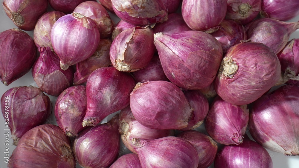 A close-up view captures the intricate textures of red shallots, showcasing their graceful curves and captivating shades, a miniature masterpiece.
A close-up view captures the intricate textures of red shallots, showcasing their graceful curves and captivating shades, a miniature masterpiece.