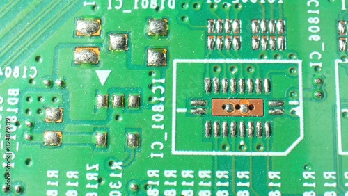 Intriguing macro zooms in on a Printed Circuit Board (PCB), unveiling the intricate web of connections in electronics. Engineering concept. 