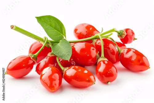 a group of red berries with green leaves photo