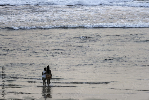 Couple Walking on Hazy Beach at Vila Nova de Milfontes, Portugal