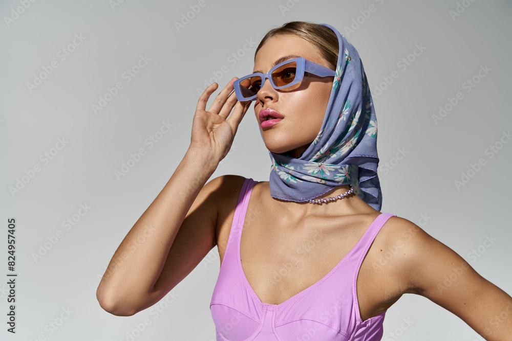 A fashionable woman wearing sunglasses and a scarf. A fashionable woman wearing sunglasses and a scarf.