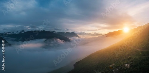 Fotografie Panoramic view of a sea of clouds below the mountains during a sunset