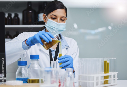 Woman, scientist and medical research for covid 19, vaccine and beaker with sample in lab for pharma innovation. Female person, technician and virus in healthcare or chemistry in forensic for testing