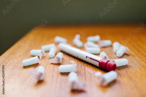 Close-up of insulin injection pen and medicine on wooden table photo