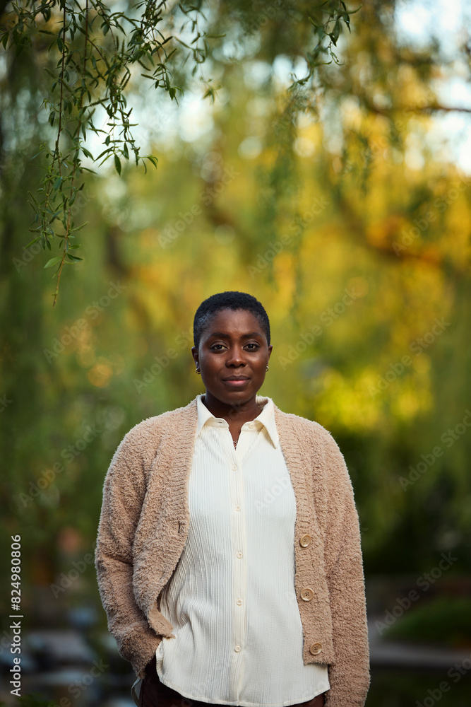 Portrait of serious mature woman standing in park Portrait of serious mature woman standing in park