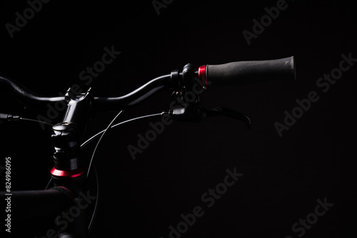 bicycle handlebar, bike isolated on black studio backdrop, bike part details