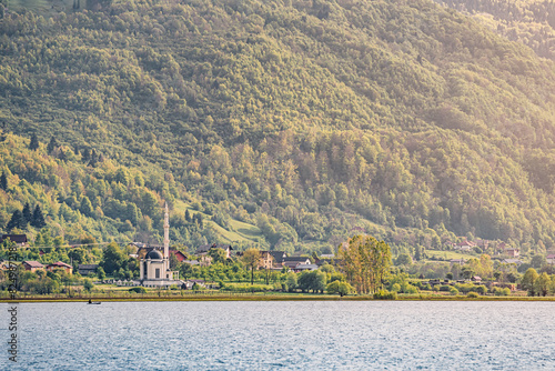 In Plav, Montenegro, a mosque overlooks the tranquil lake, blending into the scenic Balkan landscape with its traditional architecture. photo