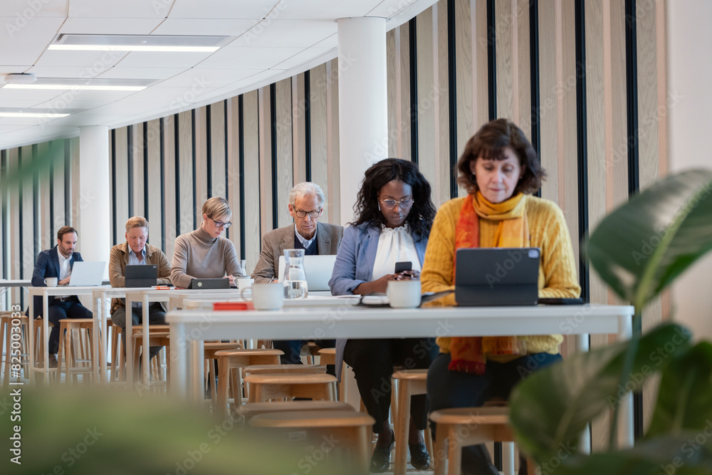 custom made wallpaper toronto digitalMultiracial colleagues using technologies at table in office cafeteria