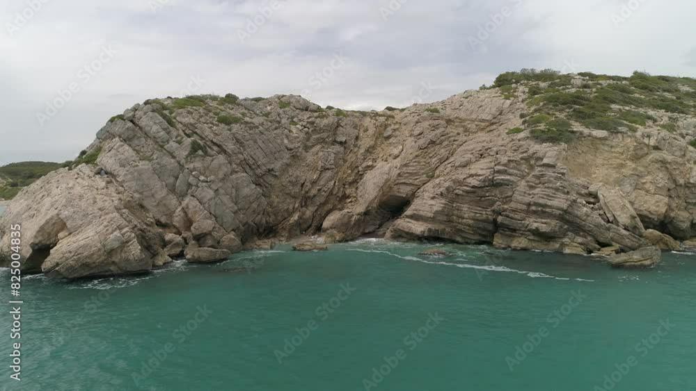 Beautiful drone view of Mediterranean sea. Turquoise water and white sand beach with rocks and cliffs. Costa Daurada, Catalonia, Spain, Europe. Beautiful drone view of Mediterranean sea. Turquoise water and white sand beach with rocks and cliffs. Costa Daurada, Catalonia, Spain, Europe.
