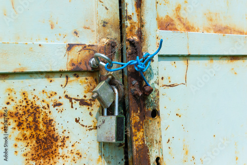 Close-Up of Rusty Padlocks On An Old Metal Door