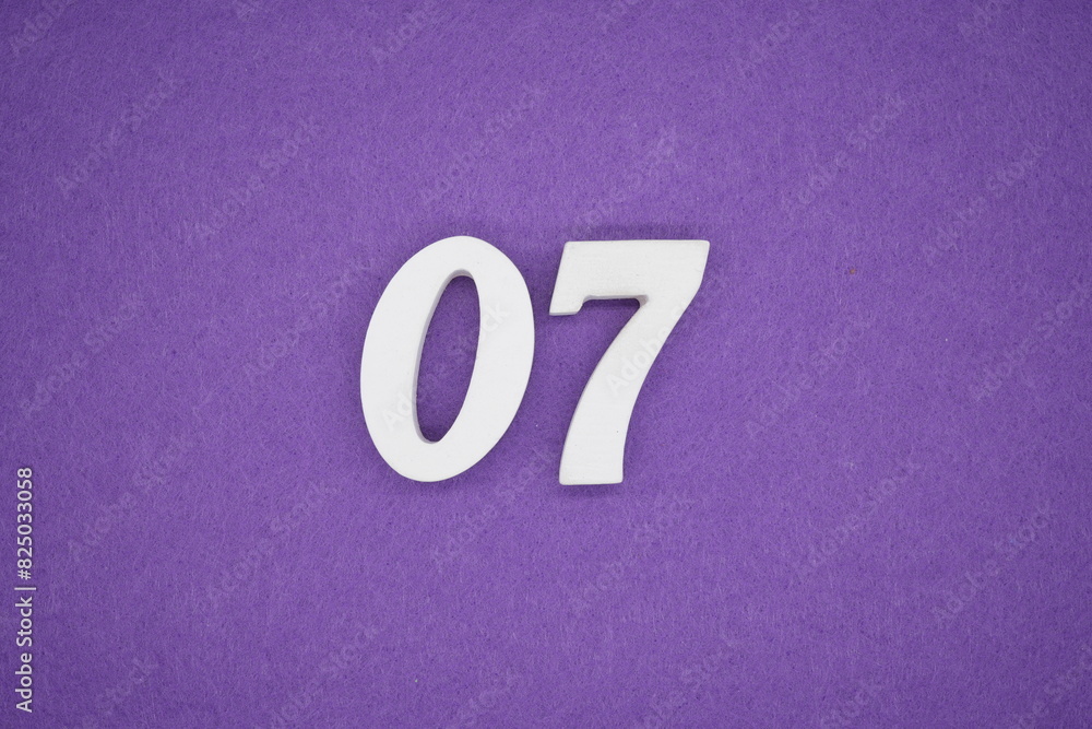 The numbers are made of white paint wood, placed on the background as a purple paper. The numbers are made of white paint wood, placed on the background as a purple paper.