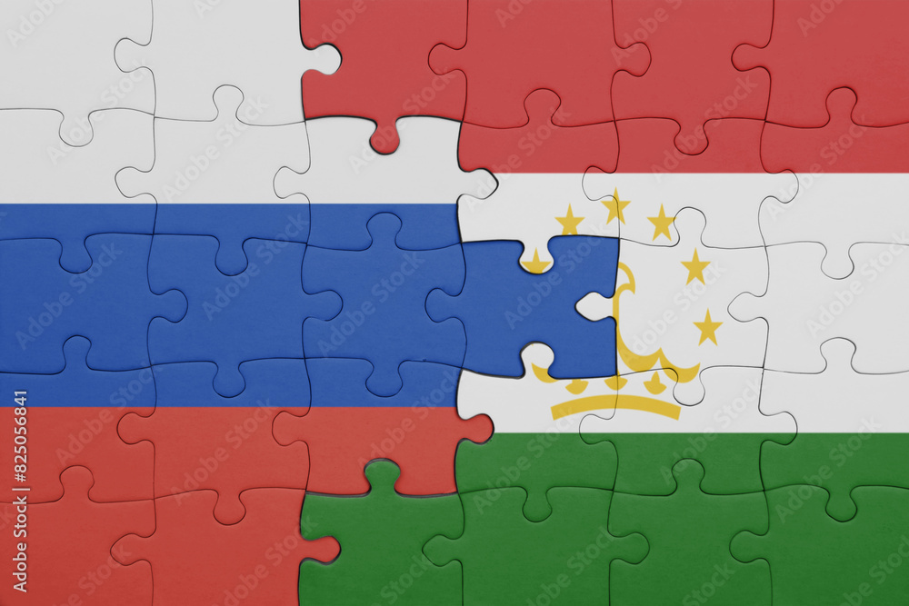puzzle with the colourful national flag of tajikistan and flag of russia. puzzle with the colourful national flag of tajikistan and flag of russia.