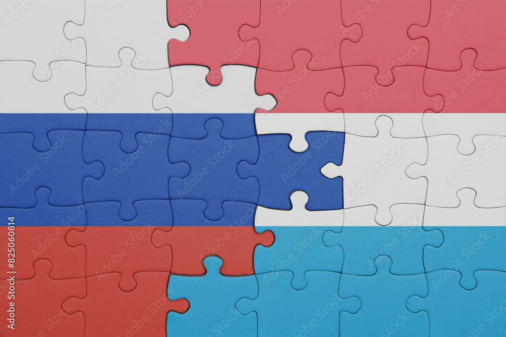 puzzle with the colourful national flag of luxembourg and flag of russia. puzzle with the colourful national flag of luxembourg and flag of russia.