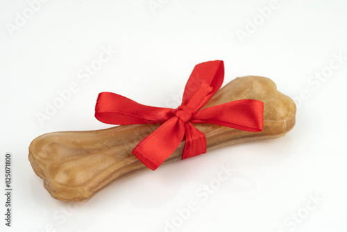 A treat for dogs - a pressed chewing bone. Isolated on white background.