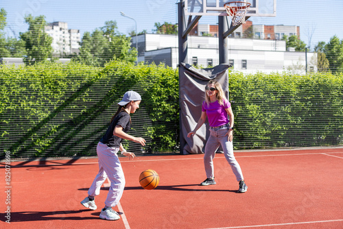 Photography Mother and daughter playing basketball.