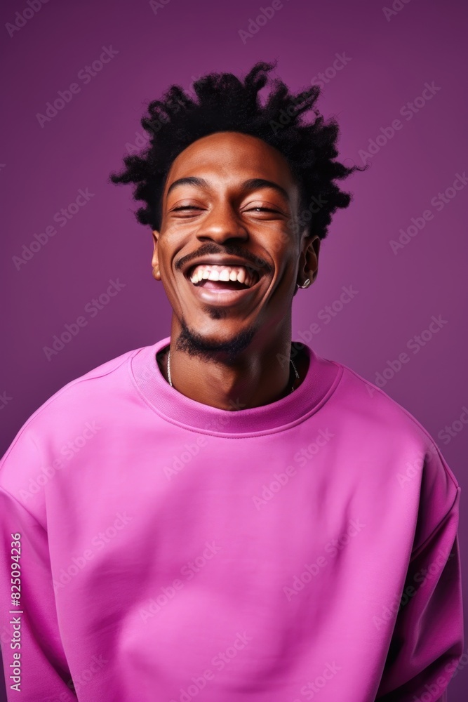 A man with a big smile on his face is wearing a pink shirt. He is posing for a picture and he is happy A man with a big smile on his face is wearing a pink shirt. He is posing for a picture and he is happy