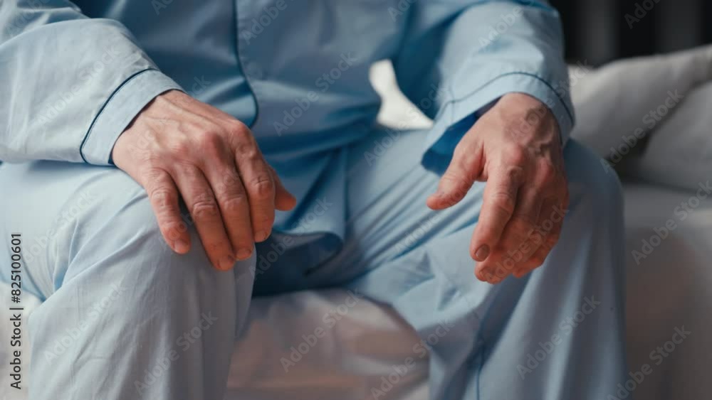 Close-up of a senior man sitting on the bed, distressed by mens health issues Close-up of a senior man sitting on the bed, distressed by mens health issues