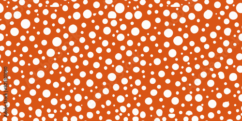 White dots of varying sizes are scattered on a bright orange background, creating a playful polka dot pattern. The pattern is dense and irregular, with no defined rhythm or arrangement of dots.AI gene