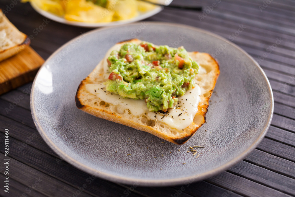 Morning toast with melted cheese and guacamol Morning toast with melted cheese and guacamol