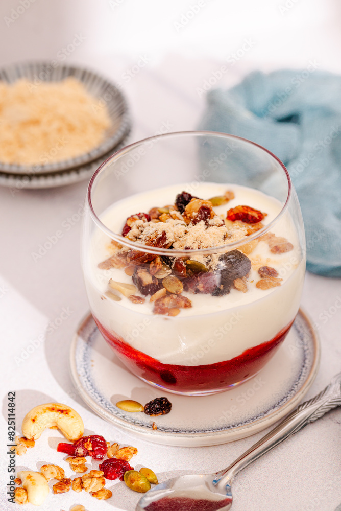 Close Up of a layered Greek Yogurt Parfait with Jam, dried berries and granola in a Glass. Light and airy real Food photography. Close Up of a layered Greek Yogurt Parfait with Jam, dried berries and granola in a Glass. Light and airy real Food photography.