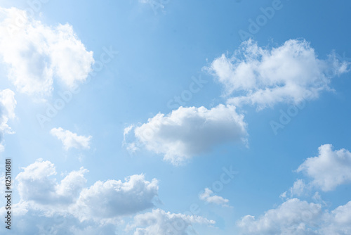 A beautiful summer day with a blue sky and fluffy white clouds photo