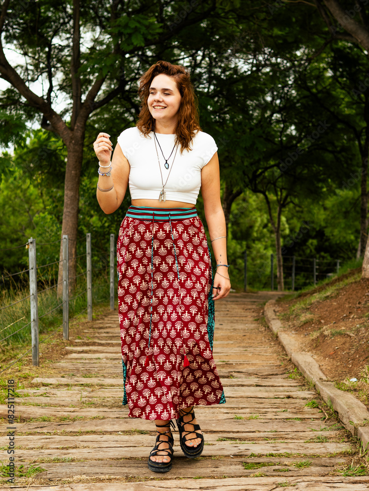 Young Woman Strolling Through a Scenic Park in Summer Afternoon Young Woman Strolling Through a Scenic Park in Summer Afternoon