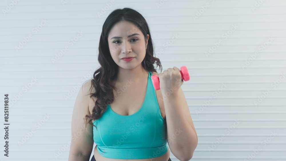 chubby woman exercising with dumbbells chubby woman exercising with dumbbells