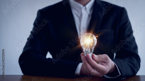 Idea innovation and inspiration concept.Hand of man holding illuminated light bulb, Idea innovation and inspiration concept. creativity with bulbs that shine glitter, Concept for success.