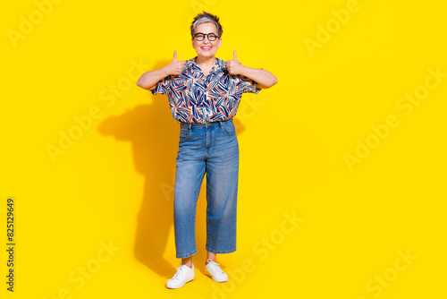 Photo of nice aged lady show thumb up wear shirt isolated on yellow color background
