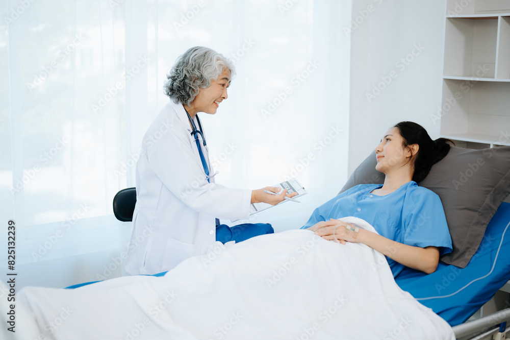 Doctor and young Female patient who lie on the bed while checking pulse, consult and explain with nurse taking note . Doctor and young Female patient who lie on the bed while checking pulse, consult and explain with nurse taking note .