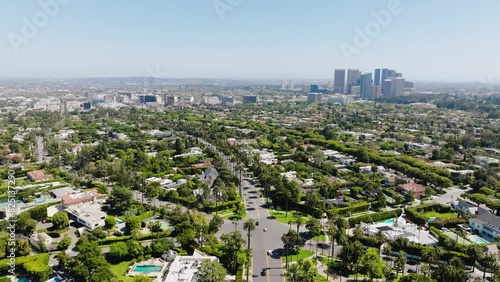 Beverly Hills Aerial 2024 - Flying from wide to low down above palm trees over road #1