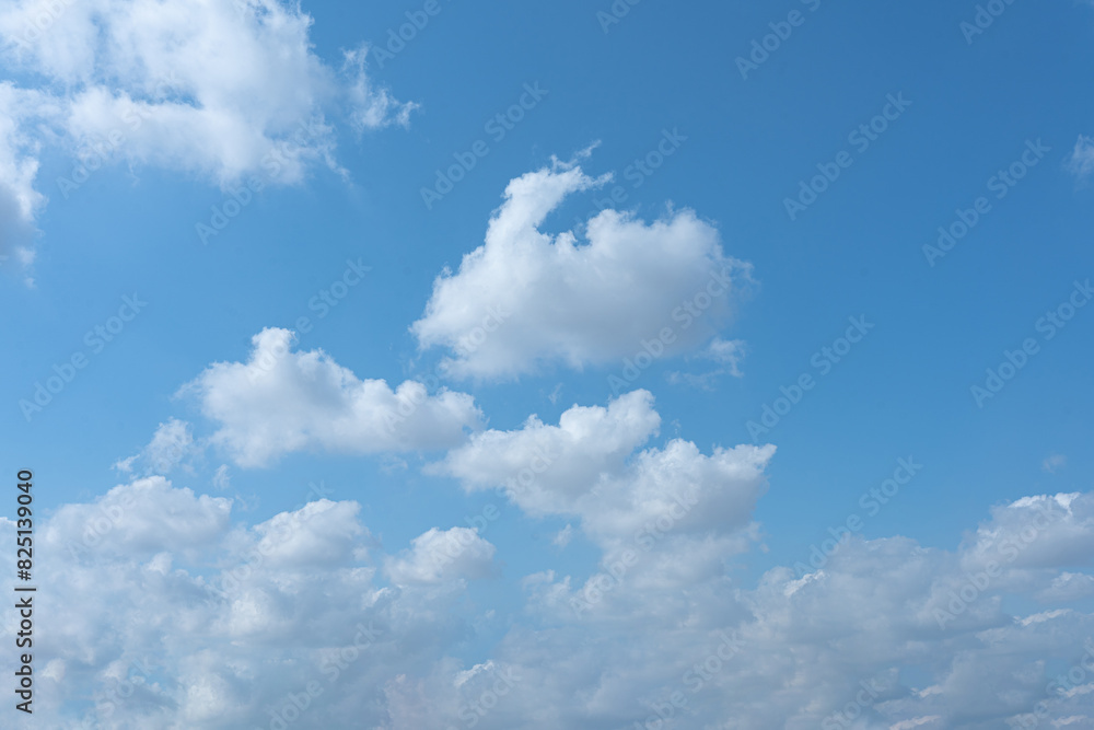 Blue Sky with Fluffy Clouds on a Sunny Day Blue Sky with Fluffy Clouds on a Sunny Day
