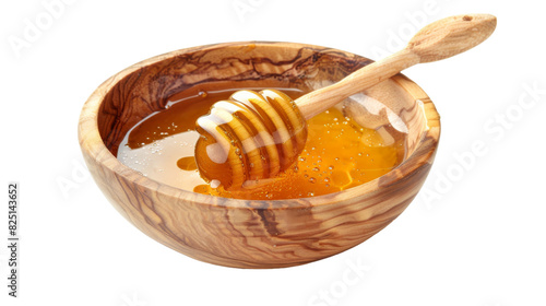 A wooden bowl filled with honey and a wooden spoon placed next to it on a wooden surface