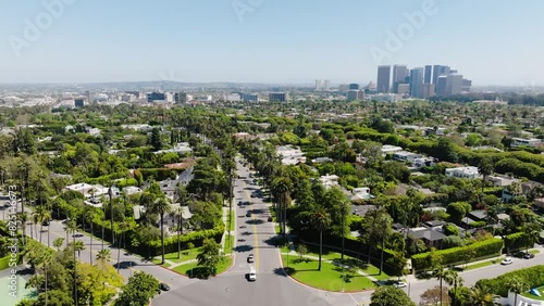 Beverly Hills Aerial 2024 - Flying from wide to low down above palm trees over road #2