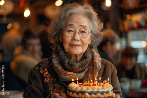 Happy asian elderly woman with Bday cake.  photo