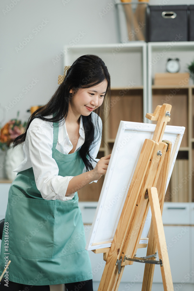 Young female artist painting on canvas in the home studio, fine arts and creativity concept. Young female artist painting on canvas in the home studio, fine arts and creativity concept.