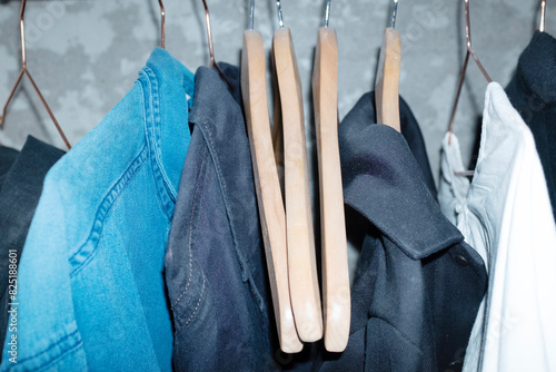 Clothes with hangers on a cloth rack with hard direct flashlight photo