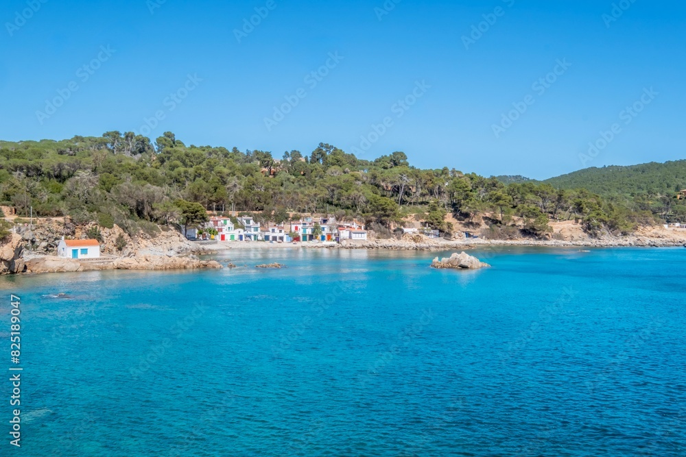 Aerial view of a small Mediterranean fishermen neighborhood, on the shore of a rocky beach. Cala S'alguer, Palamos, Costa Brava, Girona, Catalonia, Spain Aerial view of a small Mediterranean fishermen neighborhood, on the shore of a rocky beach. Cala S'alguer, Palamos, Costa Brava, Girona, Catalonia, Spain