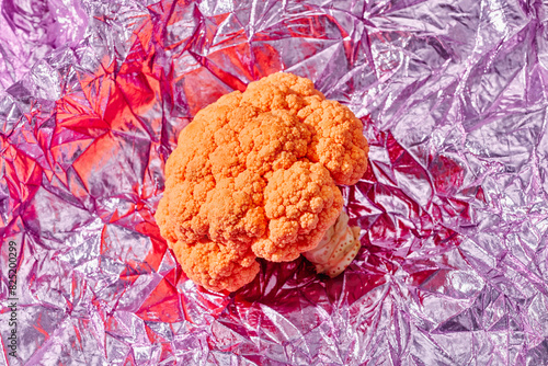 orange cauliflower on a pink fabric
