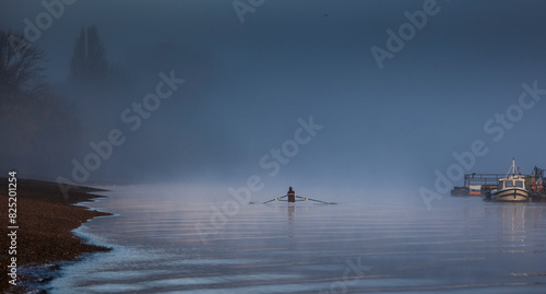 A lone rower on a river photo