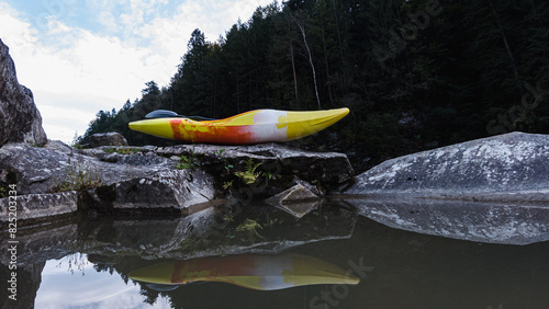 Yellow kayak on big stone. photo