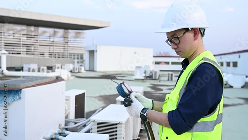 Refrigeration and Air Conditioning Engineering Detects Plant Cooling Problems,electrician maintenance Condensing on the rooftop outdoors of large industrial building,engineer under checking the indust photo