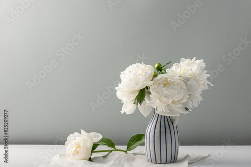 Fragrant white peonies in a vase. Summer mood. Greeting card, copy space.