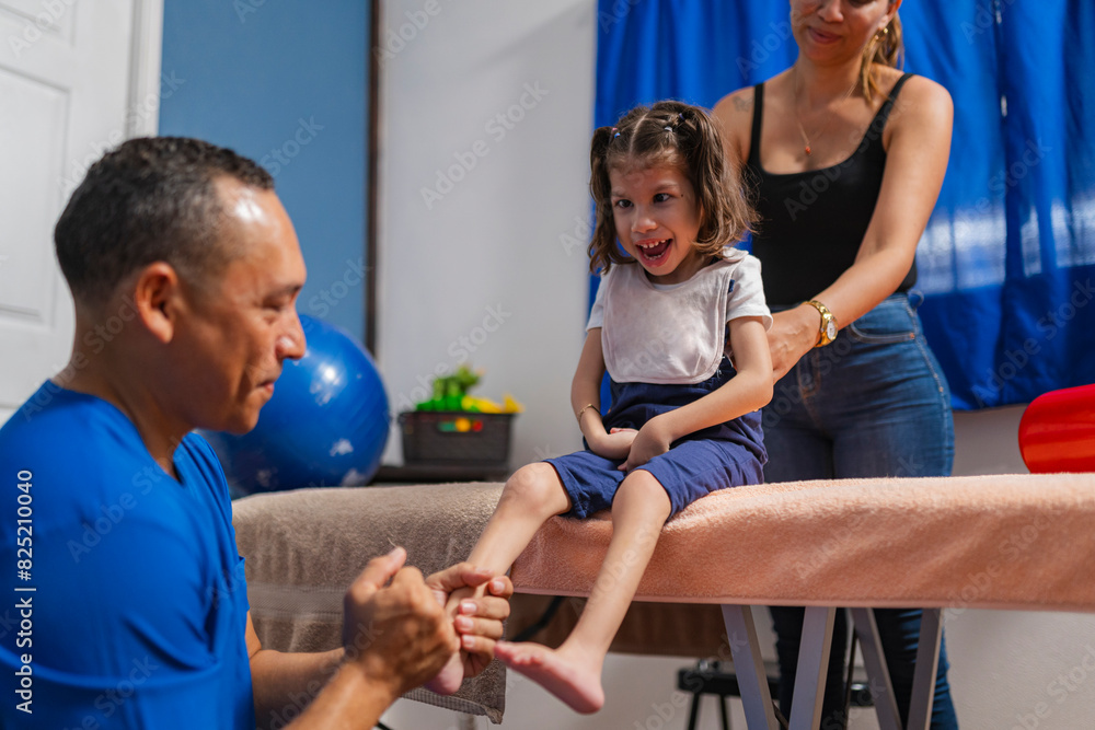 Smiling physiotherapist checking up on patient feet in clinic Smiling physiotherapist checking up on patient feet in clinic